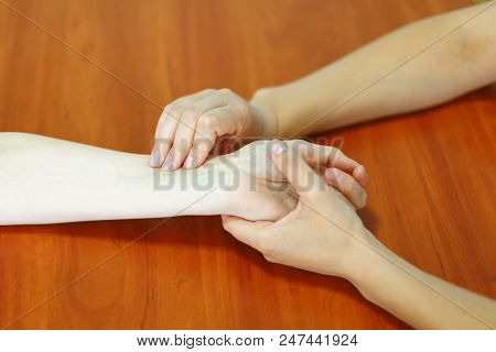 Female Doctor Checking The Aged Patient Heart Pulse