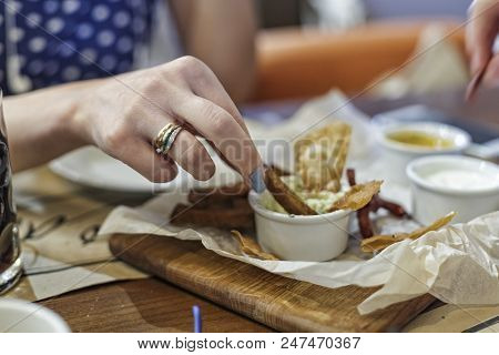 View On Girl Having Snack For Beer, In The Bar, Close-up, Assorted Snacks For Beer, Street Fast Food