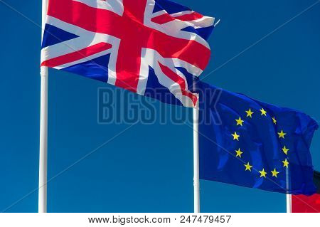British Flag And European Flag Waving Against Blue Sky In Wimereux, France.