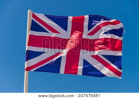 British Flag Waving Against Blue Sky In Wimereux, France.