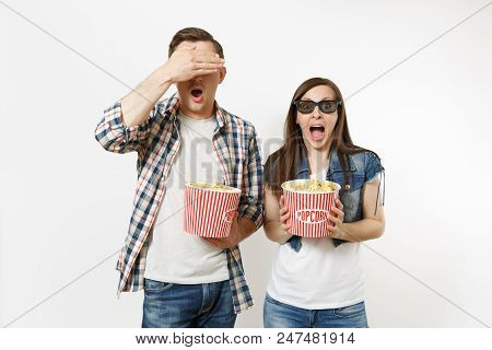 Young Scared Couple, Woman And Man In 3d Glasses Watching Movie Film On Date Holding Buckets Of Popc
