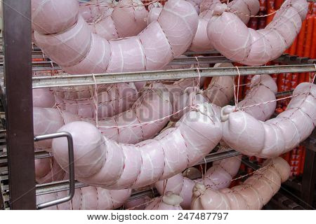 Sausage. Sausage Production Line. Sausage On The Counter For The Smokehouse. Industrial Manufacture