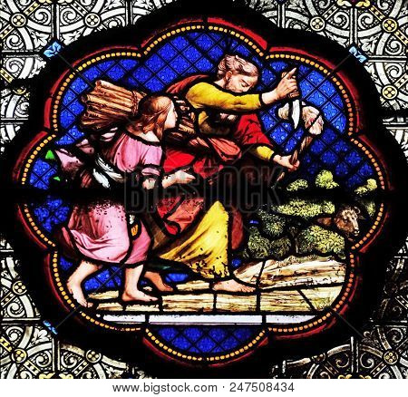 PARIS, FRANCE - JANUARY 05, 2018: Isaac carrying the wood of the sacrifice, prefiguration of the carrying of the Cross, stained glass window in the Basilica of Saint Clotilde in Paris, France.