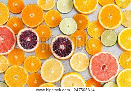 Colorful Fresh Cut Citrus Fruit Background With A Large Assortment Of Halved Different Fruits Showin