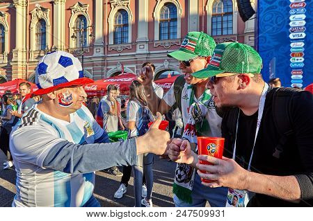 St. Petersburg, Russia - June 25, 2018: Russian And Mexican Football Fans They Greet Each Other In F