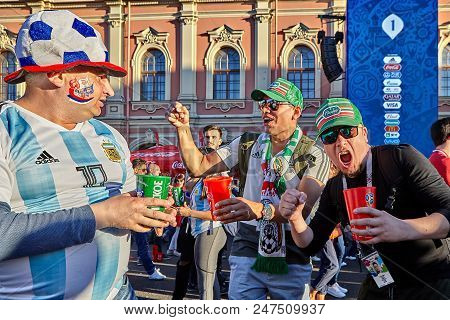 Saint Petersburg, Russia - June 25, 2018: Russian And Mexican Football Fans They Greet Each Other In