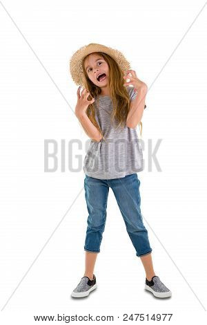 Angry Young Girl In Jeans And A Straw Sunhat Standing Clawing At The Air And Gnashing Her Teeth Isol