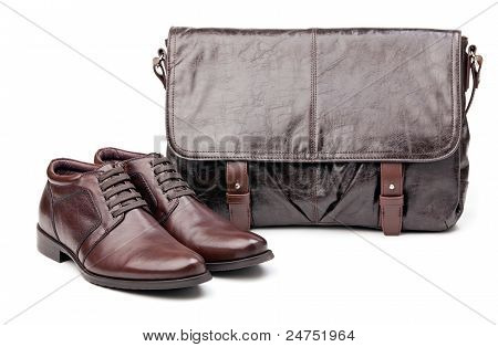 Pair of men boots and messenger bag over white