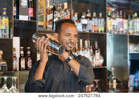 Professional Bartender Man Holding In Hands A Shaker With A Fresh Delicious Cocktail. Bartender Shak