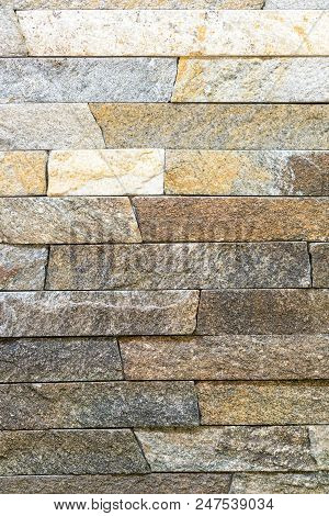 Decorative Stone For Decoration Of The Fireplace. Background. Vertical Photo.