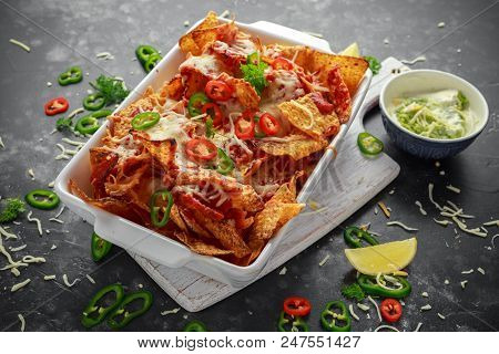Maxican-style Tortilla Nachos Chips Topped With Tomato Salsa, Sliced Chilies And Melted Cheese Serve