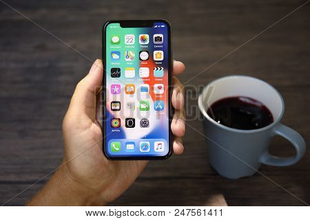 Koh Samui, Thailand - March 22, 2018: Man Hand Holding Iphone X With Home Screen Ios. Iphone 10 Was 