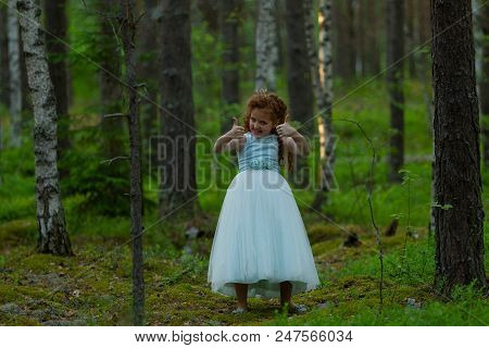 Little Emotional Girl Walks In A Summer Forest In A Dress