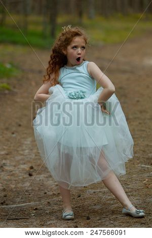 Little Emotional Girl Walks In A Summer Forest In A Dress