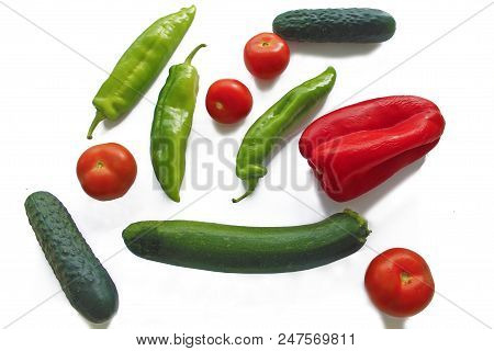 Mix Of Vegetables On White Back Ground. Tomatoes, Green Pepper, Red Pepper, Cucumber And Zucchini. F