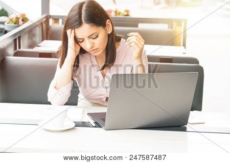 Young And Beautiful Business Woman Tired Of Work In The Office. Woman Holding Her Head.