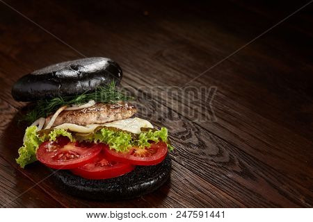 Black Burger On Vintage Wooden Background, Top View, Close-up, Selective Focus, Blurred. Some Copy S