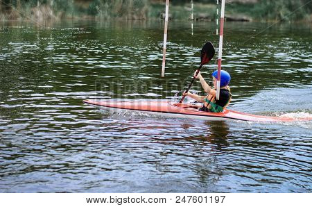 Young Teenager Girl Actively Manages A Sports Kayak Boat On A Beautiful River
