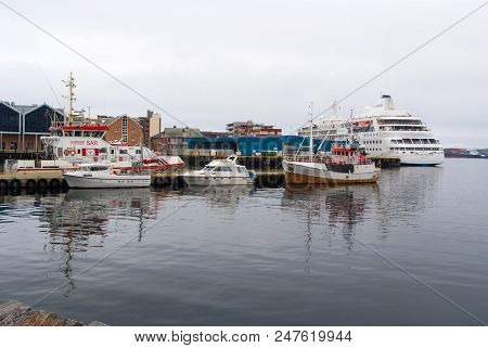 Hammerfest, Norway - January 21, 2010: Ships And Boats In Sea Dock On Grey Sky. Water Transport And 