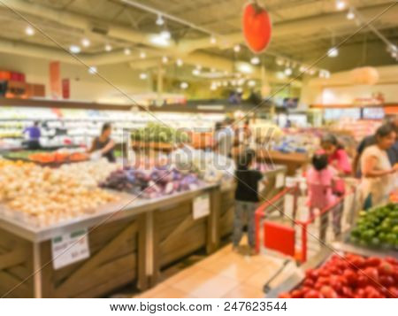 Abstract Blurred Busy Customer Shopping For Fresh Vegetables In Grocery Store