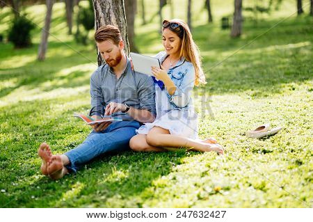 Beautiful Couple Studying Together For Exams In Nature