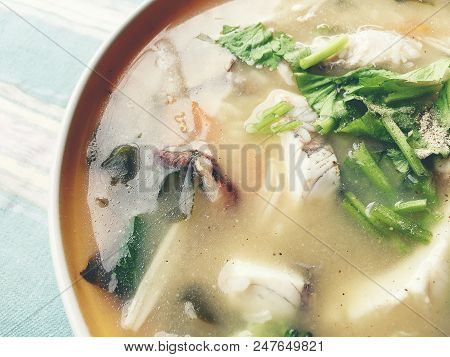 Homemade Rice Soup With Vegetables And King Fish In White Bowl. Thai Style Food.
