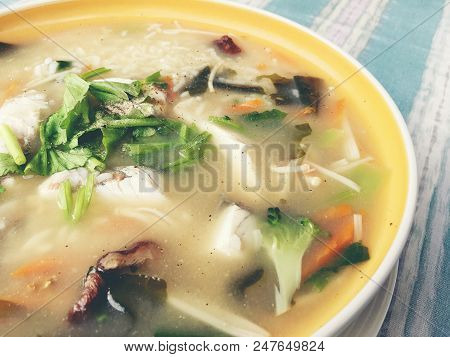 Homemade Rice Soup With Vegetables And King Fish In White Bowl. Thai Style Food.