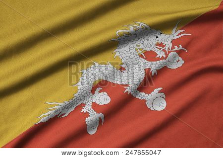 Bhutan Flag  Is Depicted On A Sports Cloth Fabric With Many Folds. Sport Team Waving Banner