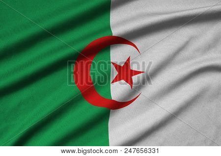 Algeria Flag  Is Depicted On A Sports Cloth Fabric With Many Folds. Sport Team Waving Banner