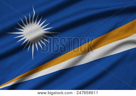 Marshall Islands Flag  Is Depicted On A Sports Cloth Fabric With Many Folds. Sport Team Waving Banne