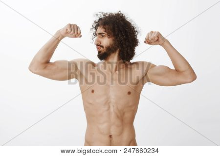 Strong And Confident Man Bragging About Mascules. Self-assured Good-looking Boyfriend With Curly Hai