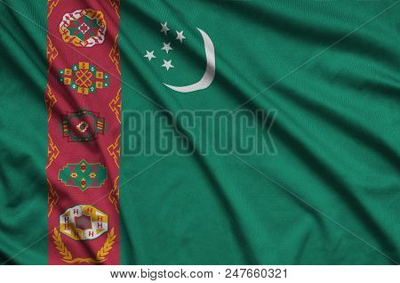 Turkmenistan Flag  Is Depicted On A Sports Cloth Fabric With Many Folds. Sport Team Waving Banner