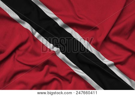 Trinidad And Tobago Flag  Is Depicted On A Sports Cloth Fabric With Many Folds. Sport Team Waving Ba