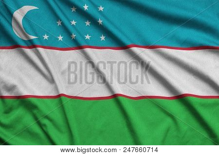 Uzbekistan Flag  Is Depicted On A Sports Cloth Fabric With Many Folds. Sport Team Waving Banner