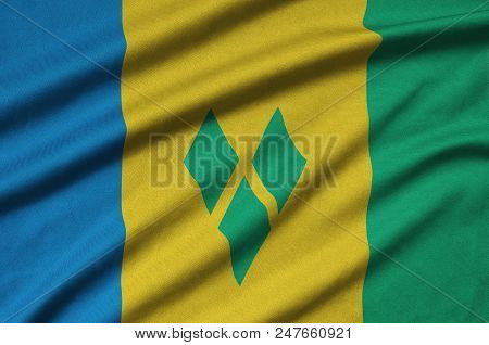 Saint Vincent And The Grenadines Flag  Is Depicted On A Sports Cloth Fabric With Many Folds. Sport T