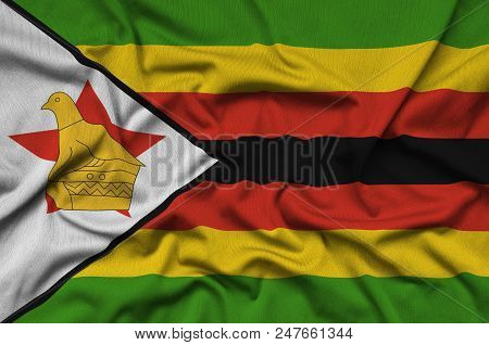 Zimbabwe Flag  Is Depicted On A Sports Cloth Fabric With Many Folds. Sport Team Waving Banner