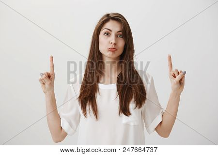 Shame To Lose Such Offer. Portrait Of Good-looking Gloomy Girl Pointing Up With Index Fingers And Su