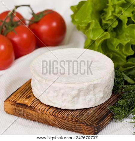 Camembert Cheese On Wooden Board With Tomatoes And Green Salad. Serving French Homemade Soft Cheese.