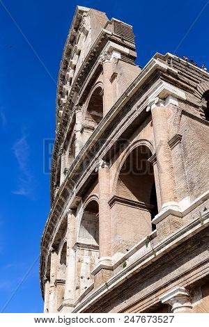 Closeup Colosseum In Rome, With Dlue Sky In Background. Concept Of Last Minute Tours To Italy And Vi