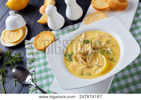 Avgolemono - Delicious Creamy Greek Chicken Soup With Lemon, Egg Yolk, Pasta Risini And Herbs In A W