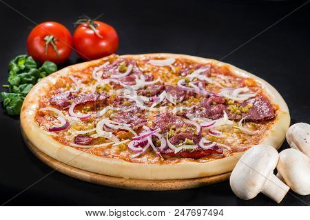Delicious Tasty Diablo Pizza With Mozzarella, Beef, Onion, Pepper And Sauce On Wooden Board On Dark 
