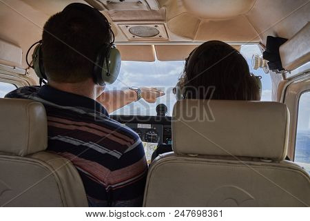 Two Pilots Sitting In A Cockpit Of Cessna Skyhawk 172 Airplane.