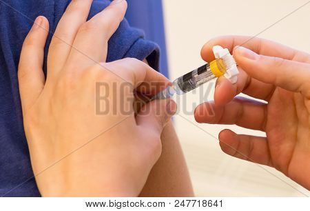 Doctor Vaccinating A Young Woman