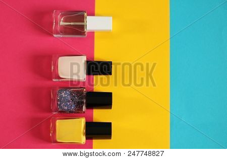 Nail Polish Concept, Pink, Yellow And Blue Background