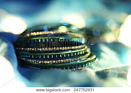 Silver And Blue Bangles On The Light Blue Background, Selective Focus