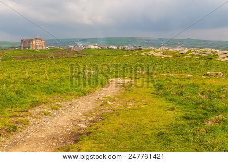 Tintagel, United Kingdom - May 02, 2014: View Of Tintagel Island And Legendary Tintagel Castle Ruins