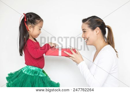 Attractive Asian Girl Received A Present At Brithday With Her Family. Kid Holding Gift With Attracti