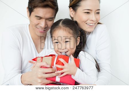 Attractive Asian Family Holding With Each Other. Kid Received Gift With Attractive Smiling. Kid With