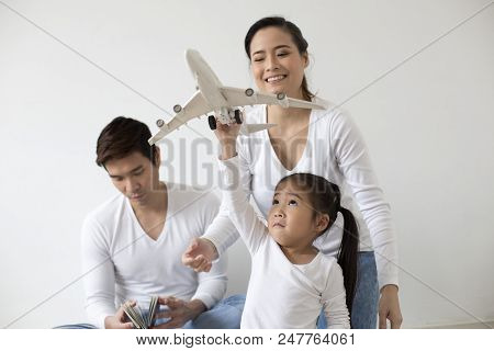 Asian Girl Playing Airplane At Home. Kid Playing Airplane With Attractive Smiling. People With Trave