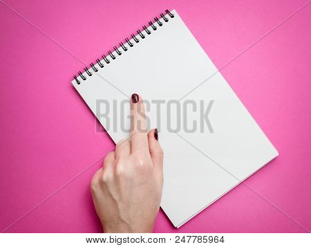 Design Concept - Top View Of Man's Hand Holding Hardcover Gray Linen Notebook And Ballpoint Pen Isol
